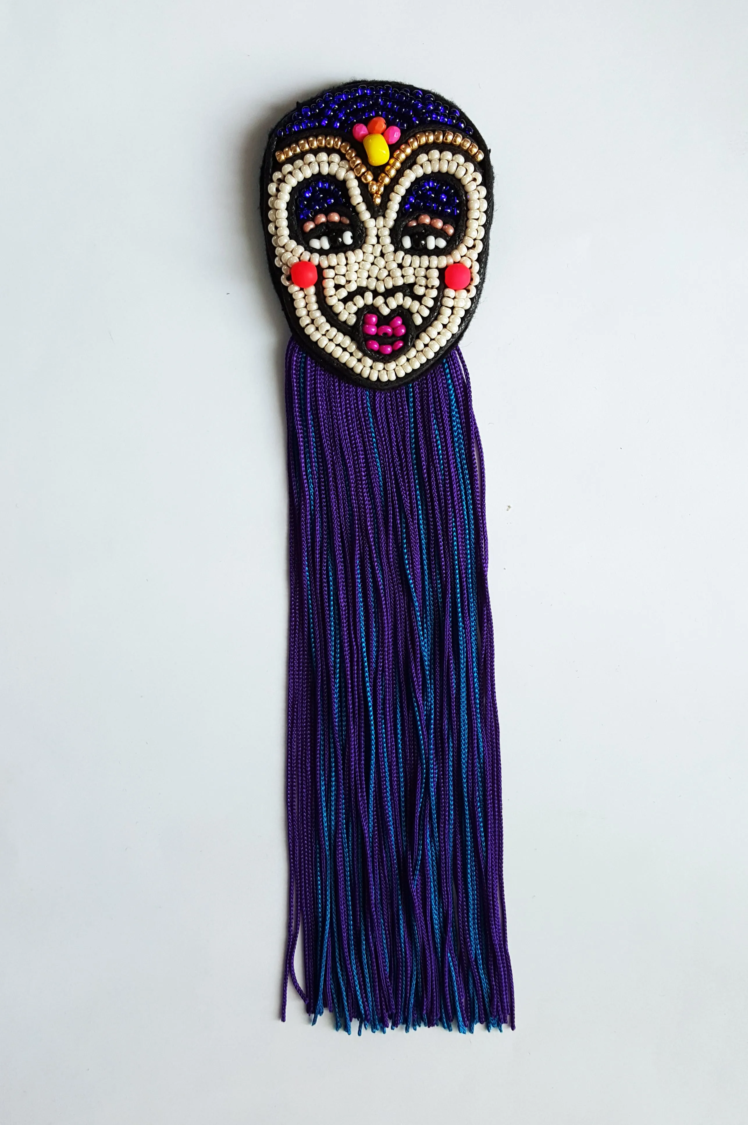 Colorful Rigoletto Inspired Mask Brooch with Long Blue and Purple Fringe